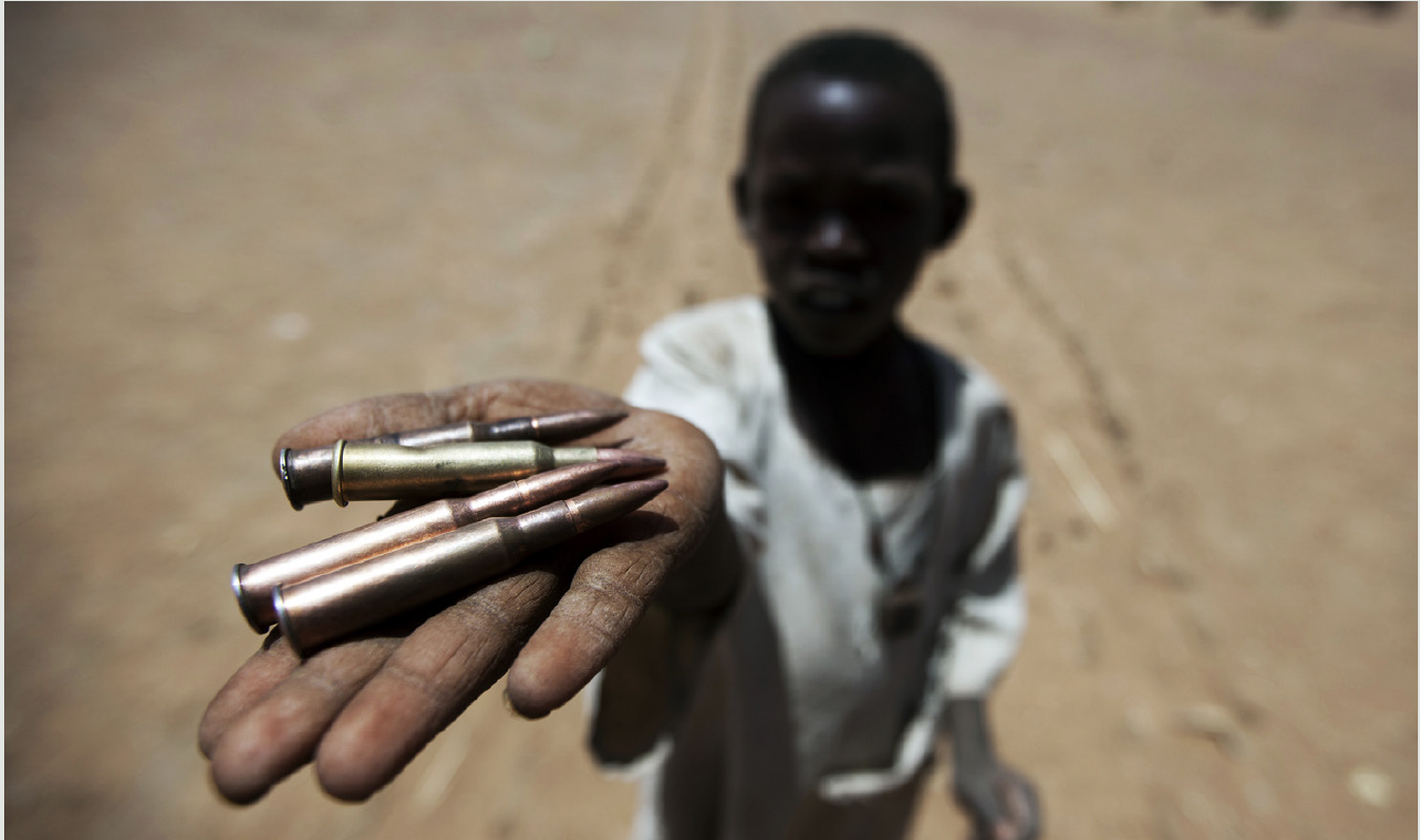 A child holds bullets.
