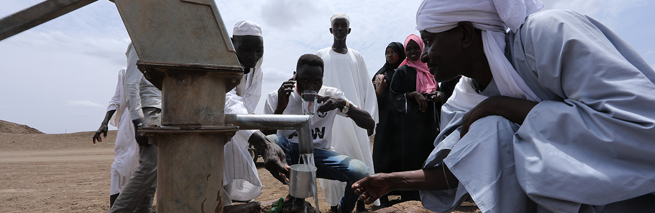 people in south sudan gathering water from a well